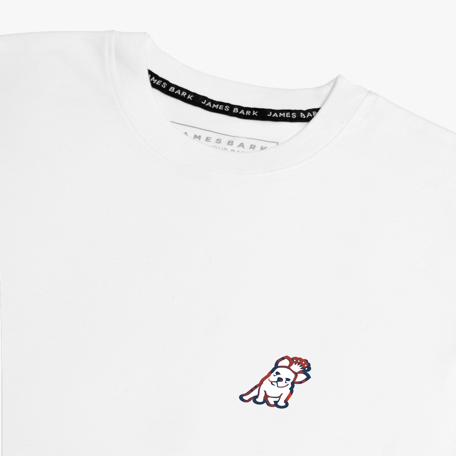 Flat-lay front view of the white t-shirt displaying the small embroidered logo on the chest.
