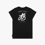 A flat lay of the back of the black T-shirt, showing the large white graphic with the text "James Bark Privé Society" and the rope initials "JB."