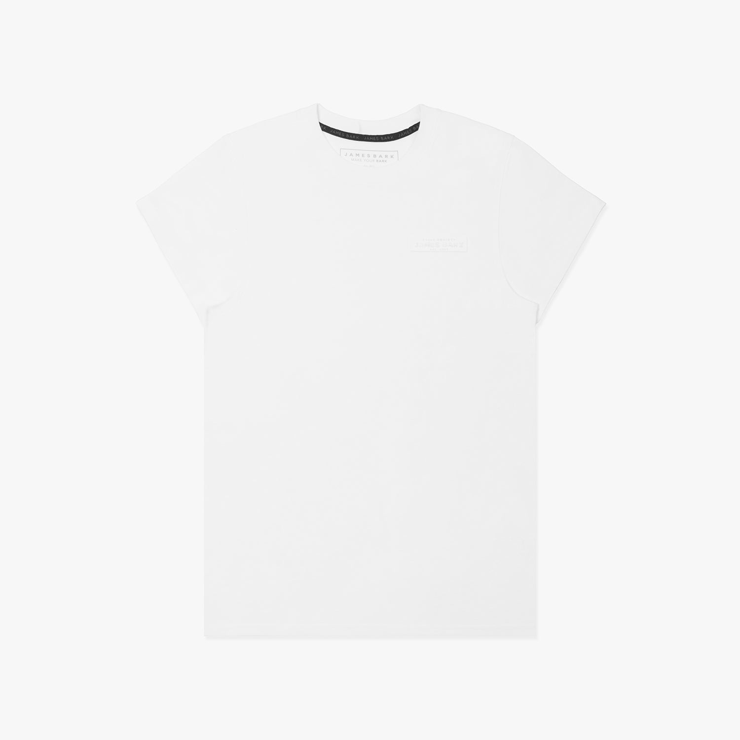 A white short-sleeved T-shirt featuring a subtle tonal logo patch on the upper left chest area that reads 'JAMES BARK.' The neckline includes a black inner lining with repeated 'JAMES BARK' branding, and the inside label also displays the brand name