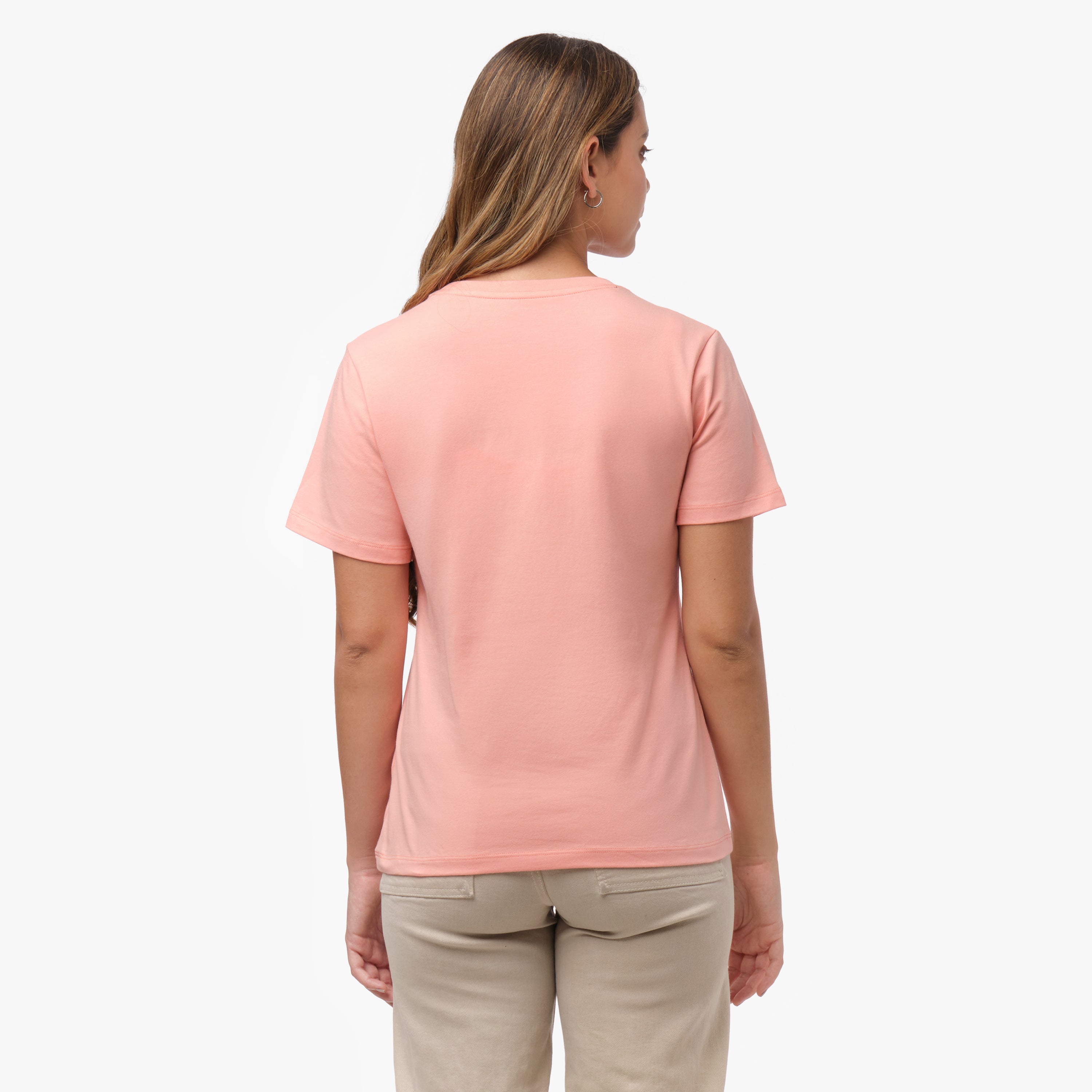 Back view of a woman wearing a plain peach-colored t-shirt and beige wide-leg pants