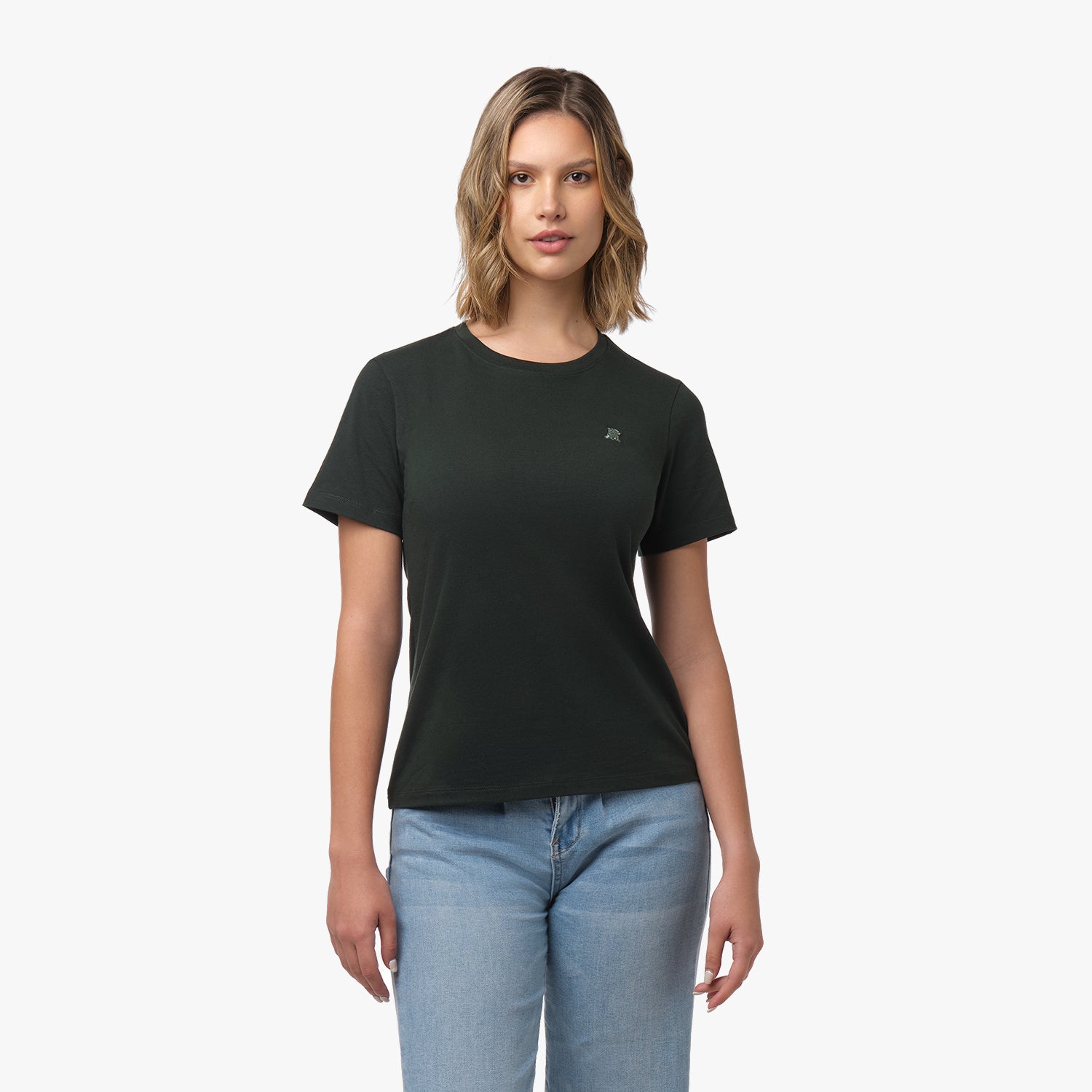 Woman facing forward wearing a dark green t-shirt with small tone-on-tone embroidered dog logo on left chest and blue wide-leg jeans