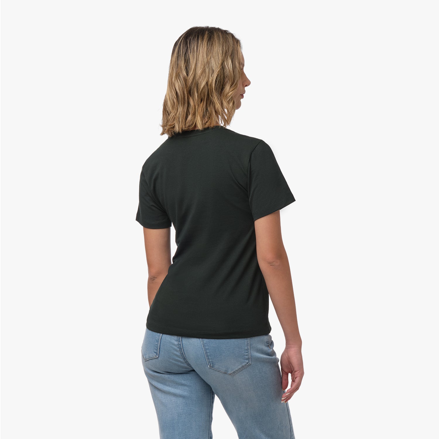 Back view of a woman wearing a plain dark green t-shirt and blue wide-leg jeans