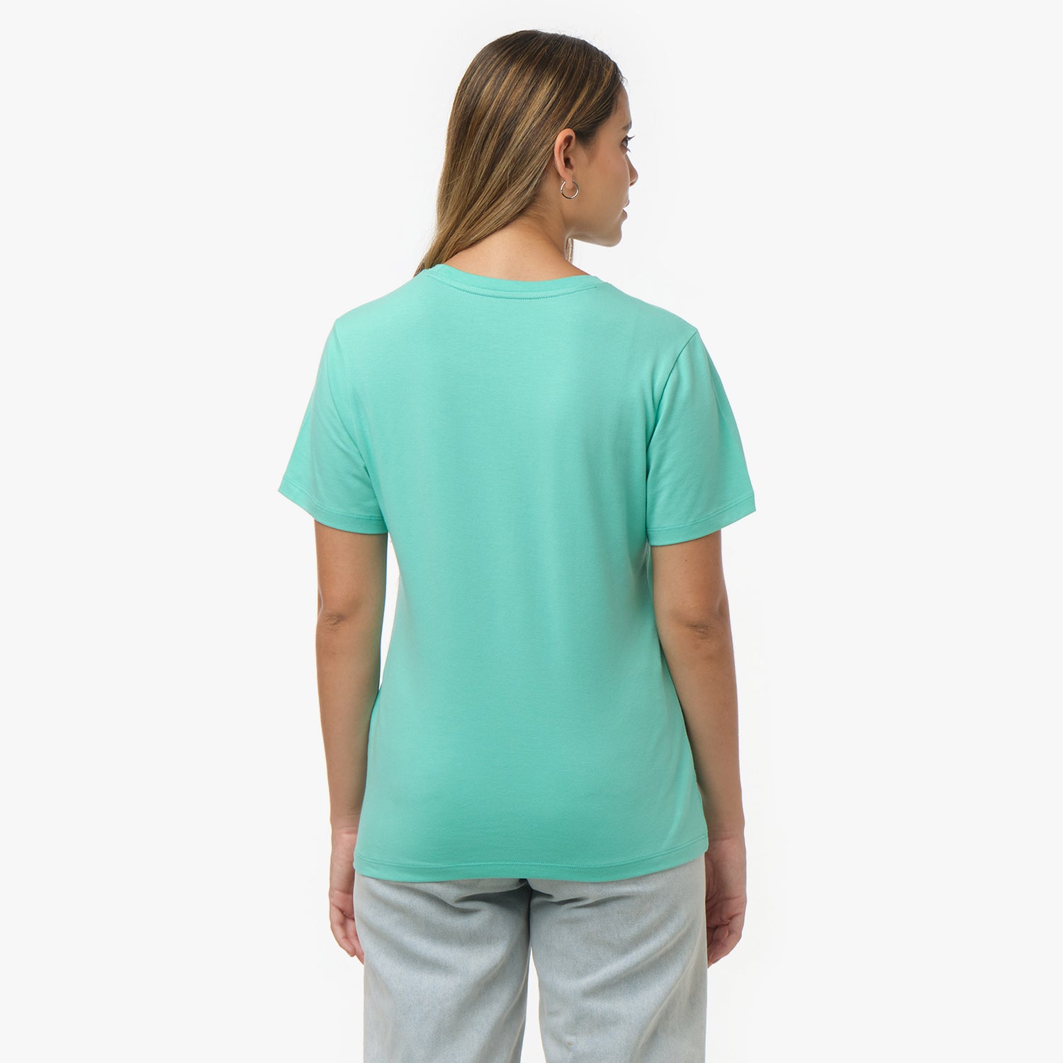 Back view of a woman wearing a plain mint green t-shirt and light wash jeans
