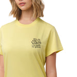 A close-up of the woman wearing the yellow T-shirt, focusing on the chest area and the black text design.