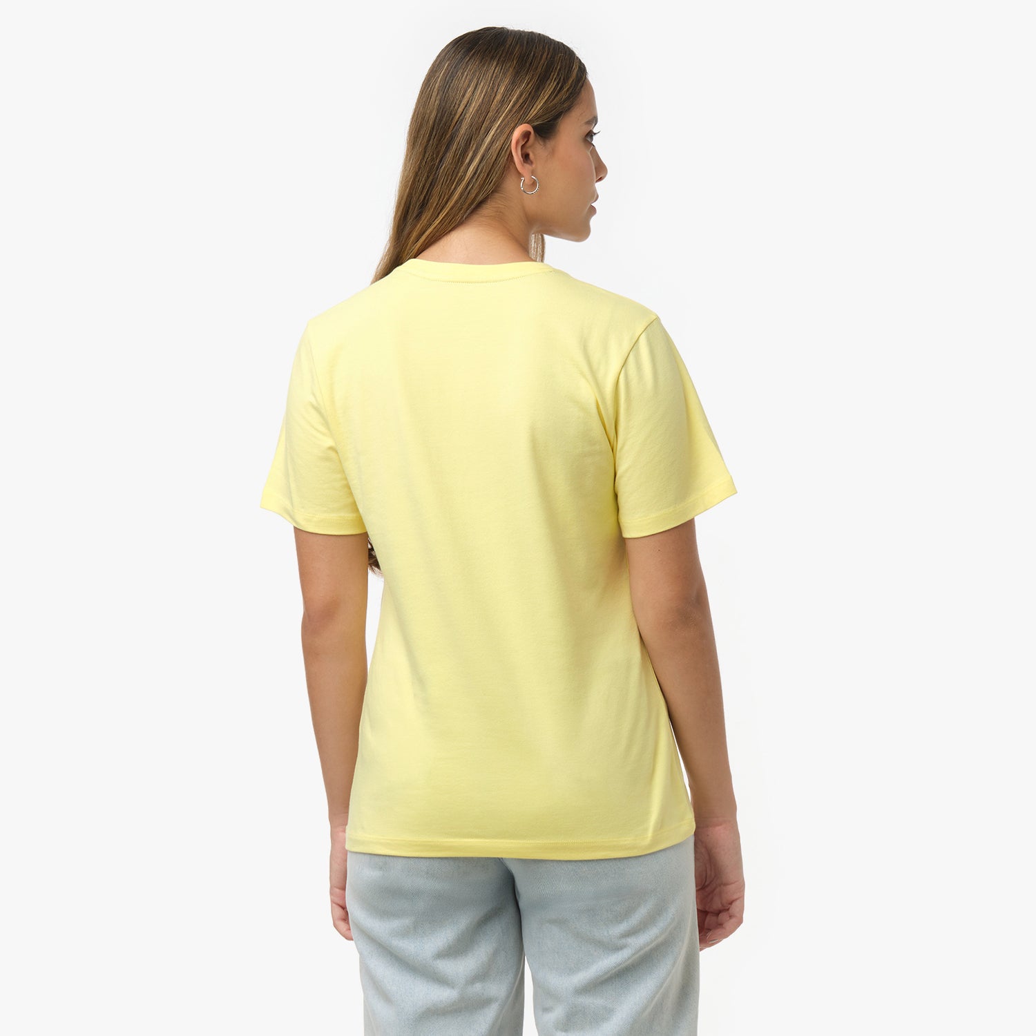 Back view of a woman wearing a plain pale yellow t-shirt and light wash jeans