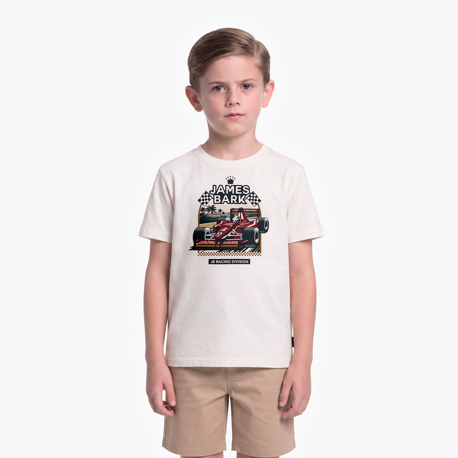 A young boy modeling a cream-colored T-shirt with a James Barker racing graphic