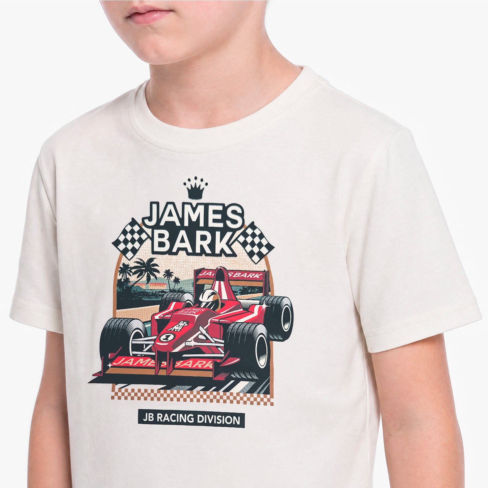 A child wearing a cream-colored T-shirt with a graphic print of a red James Bark F1 car and checkered flags.