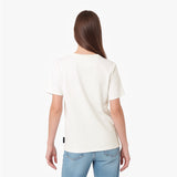 A woman viewed from the back wearing a plain off-white short-sleeve crewneck T-shirt and light blue jeans