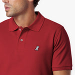 Close-up of a red polo shirt with a small logo on a white background
