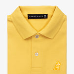 Close-up of the collar and chest area of the yellow polo shirt, showing the button placket and gold embroidered logo.