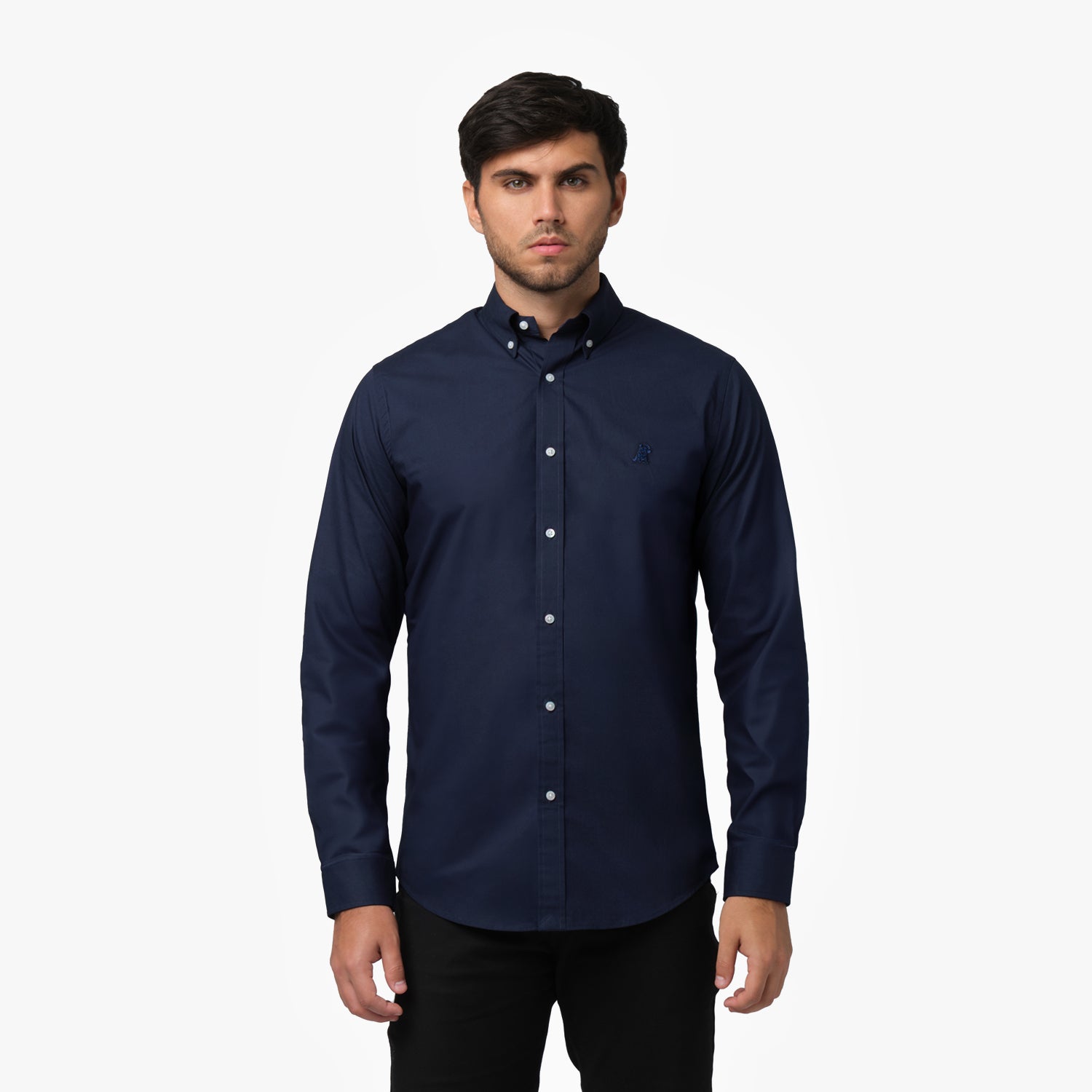 Front view of a man wearing a navy blue long-sleeved button-down shirt and black pants against a white background