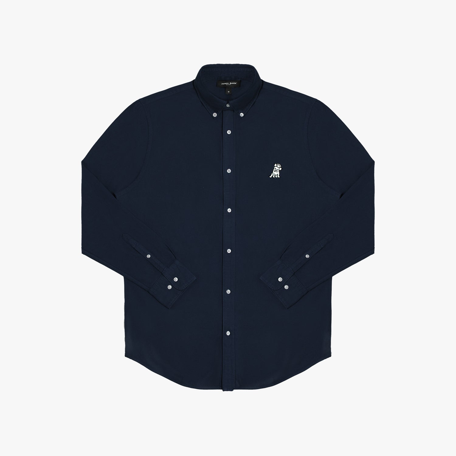 Flat lay photograph of a navy blue long-sleeve button-down oxford shirt with a small white embroidered logo on the left chest and a visible brand label inside the collar, against a white background