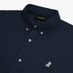 Close-up view of the collar and chest area of a navy blue James Bark oxford shirt, showing the button-down collar, placket buttons, brand label, and the small white embroidered dog logo