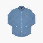 Front view of a dusty blue long-sleeved button-down shirt laid flat against a white background. It features a button-down collar, buttoned cuffs, white buttons, and a black-and-white embroidered dog logo on the left chest
