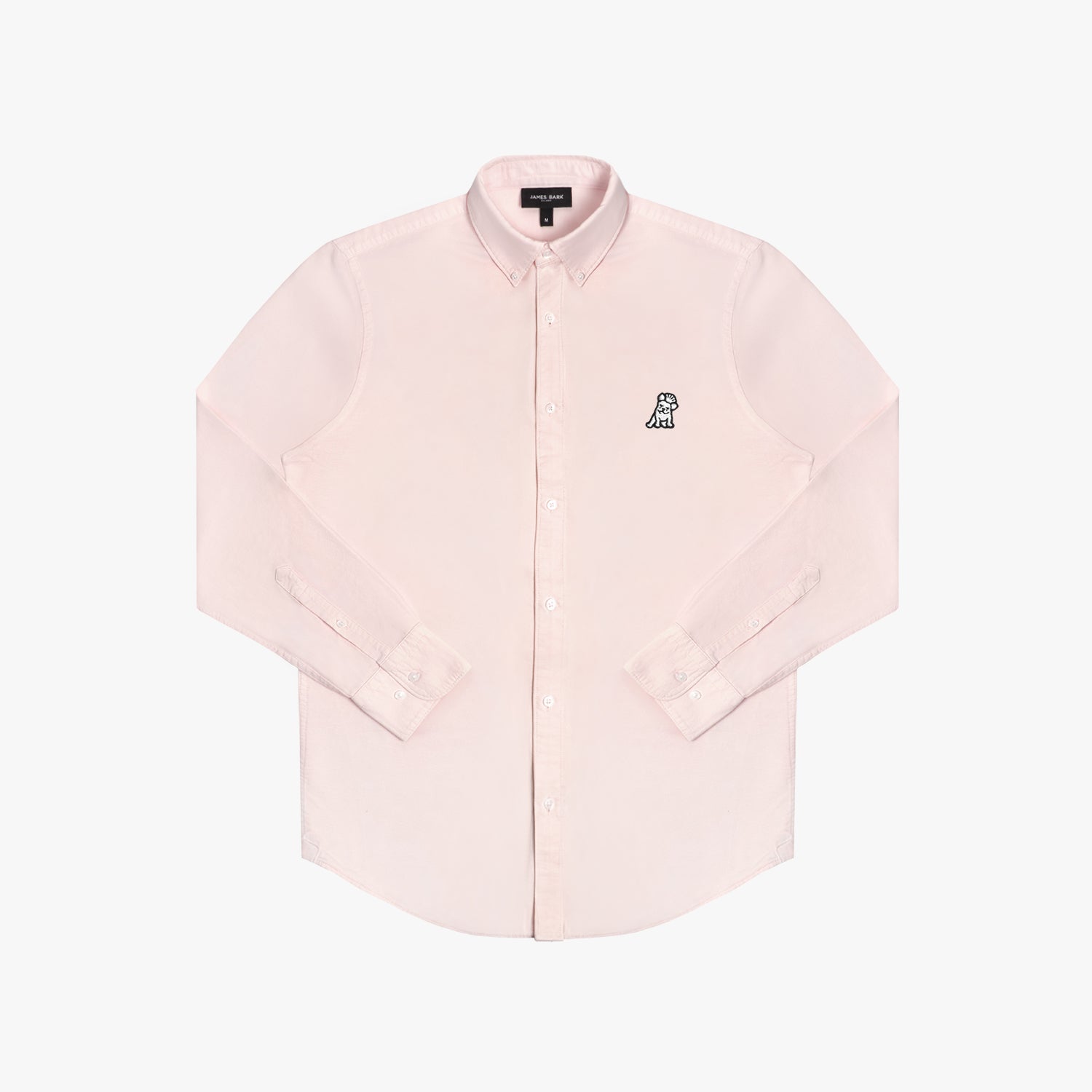 Front view of a light pink long-sleeved button-down shirt laid flat against a white background. It features a button-down collar, buttoned cuffs, and a black-and-white embroidered dog logo on the left chest