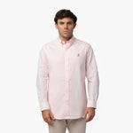Full front view of a man wearing a pink long-sleeved button-down shirt with a small logo on the chest and khaki pants, standing against a white background