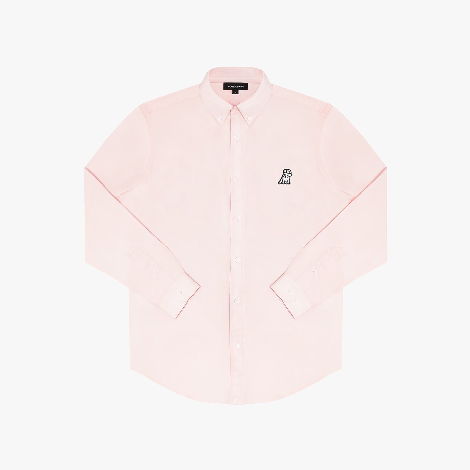 Close-up of the collar and upper chest area of a light pink button-down shirt. Features include a button-down collar, white buttons, a black "JAMES BARK" brand tag, and a black and white embroidered dog logo on the left chest