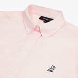 Front view of a light pink long-sleeved button-down shirt laid flat against a white background. It features a button-down collar, buttoned cuffs, and a black and white embroidered dog logo on the left chest