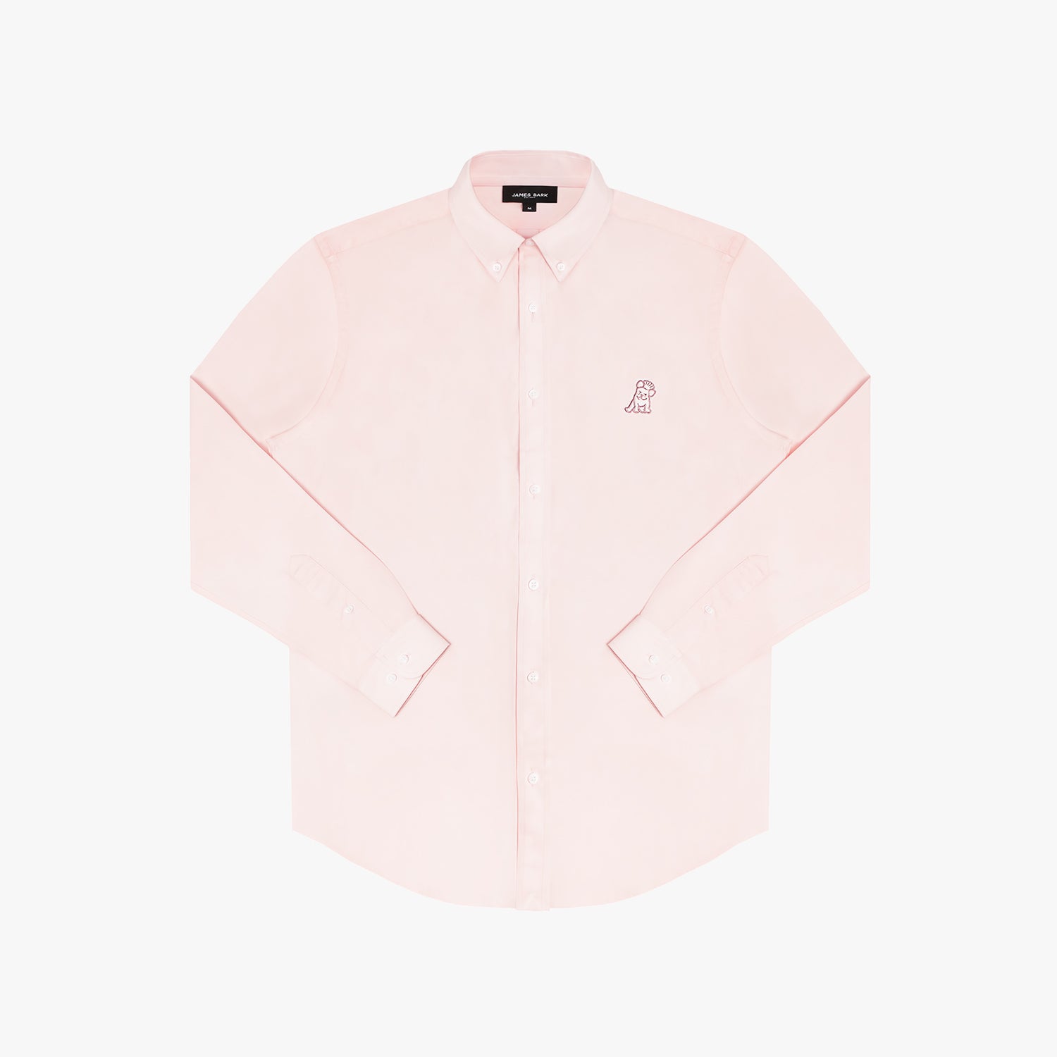 Close-up of the collar and upper chest area of a light pink button-down shirt. Features include a button-down collar, white buttons, a black "JAMES BARK" brand tag, and a pink embroidered dog logo on the left chest