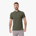 A man wearing an olive green polo shirt with a small dark embroidered logo on the left chest