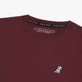 Close-up of the neckline of the burgundy shirt, showing the label and detailed stitching.