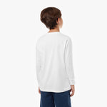 Back view of a young boy wearing the white long-sleeved t-shirt with the small dog logo and navy shorts