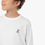 Close-up of the small embroidered dog logo (a seated dog) on the chest of the white long-sleeved t-shirt