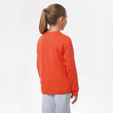 Side view of the girl wearing the orange long-sleeve shirt, showing the plain back and relaxed fit.