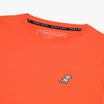 Close-up of the neckline of the orange shirt, showing the label and detailed stitching.