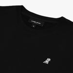 Close-up of the neckline and embroidered dog logo on the black sweatshirt, highlighting the fine details and texture