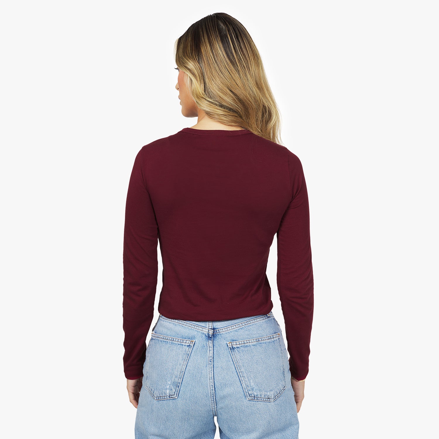 Back view of a woman wearing the burgundy long-sleeve shirt.