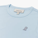 Close-up of the neckline and small dog graphic on the chest of the light blue long-sleeve shirt.