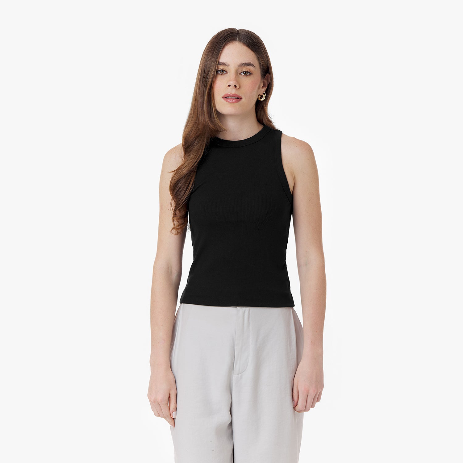 Female model wearing a black sleeveless ribbed tank top with a high neckline. The fitted silhouette is paired with light-colored wide-leg pants. Minimalist white background.