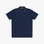 A navy blue polo shirt with white contrast piping on the collar and sleeve edges, featuring a half-zip collar and a small embroidered logo on the left chest