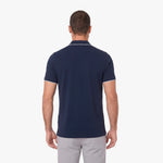Back view of a man wearing a navy blue polo on a white background