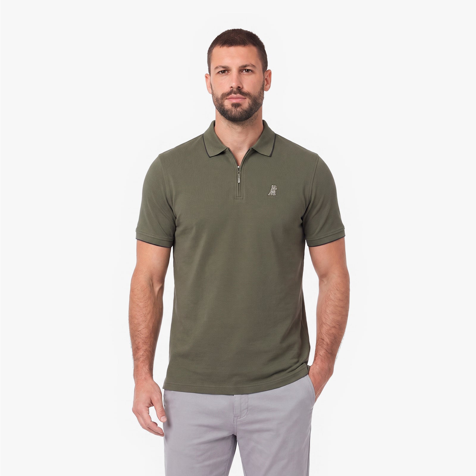 A man wearing an olive green short-sleeve polo shirt with a half-zip collar and a small embroidered logo on the left chest