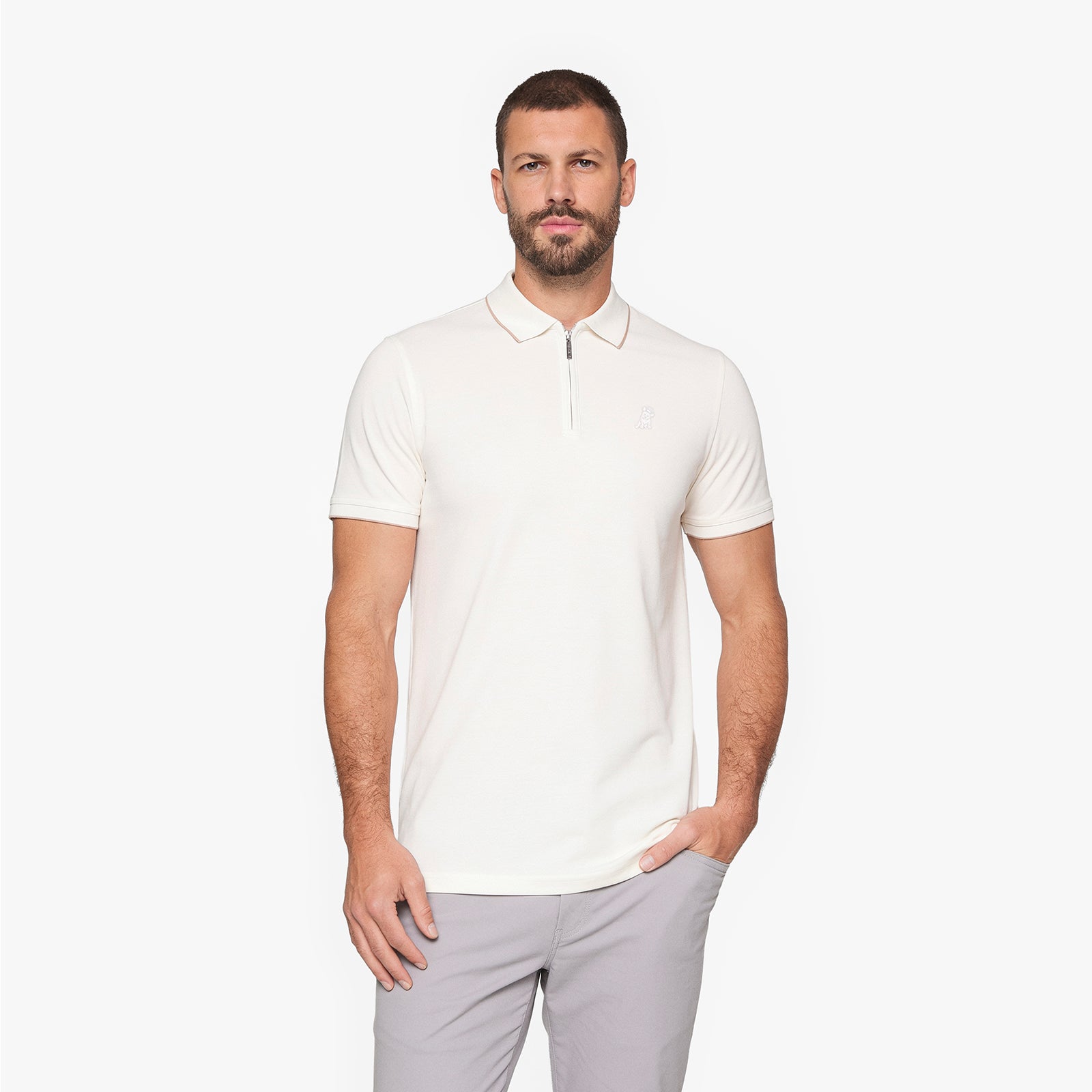 A man wearing a short-sleeve polo shirt with a half-zip collar in off-white
