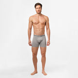 A man standing upright, modeling gray James Bark boxer briefs. The waistband of the boxer briefs features the 'JAMES BARK' branding, and the fabric is form-fitting, highlighting the comfort and fit of the product.