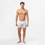 A male model wearing white James Bark boxer briefs. The briefs have a fitted design with 'JAMES BARK' branding on the waistband, which sits comfortably at the waist. The model is standing straight with a neutral expression.