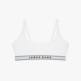 Flat-lay view of a white bralette with the "James Bark" logo on the elastic band.