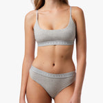 Close-up of the woman’s torso, highlighting the gray bralette and waistband detail.