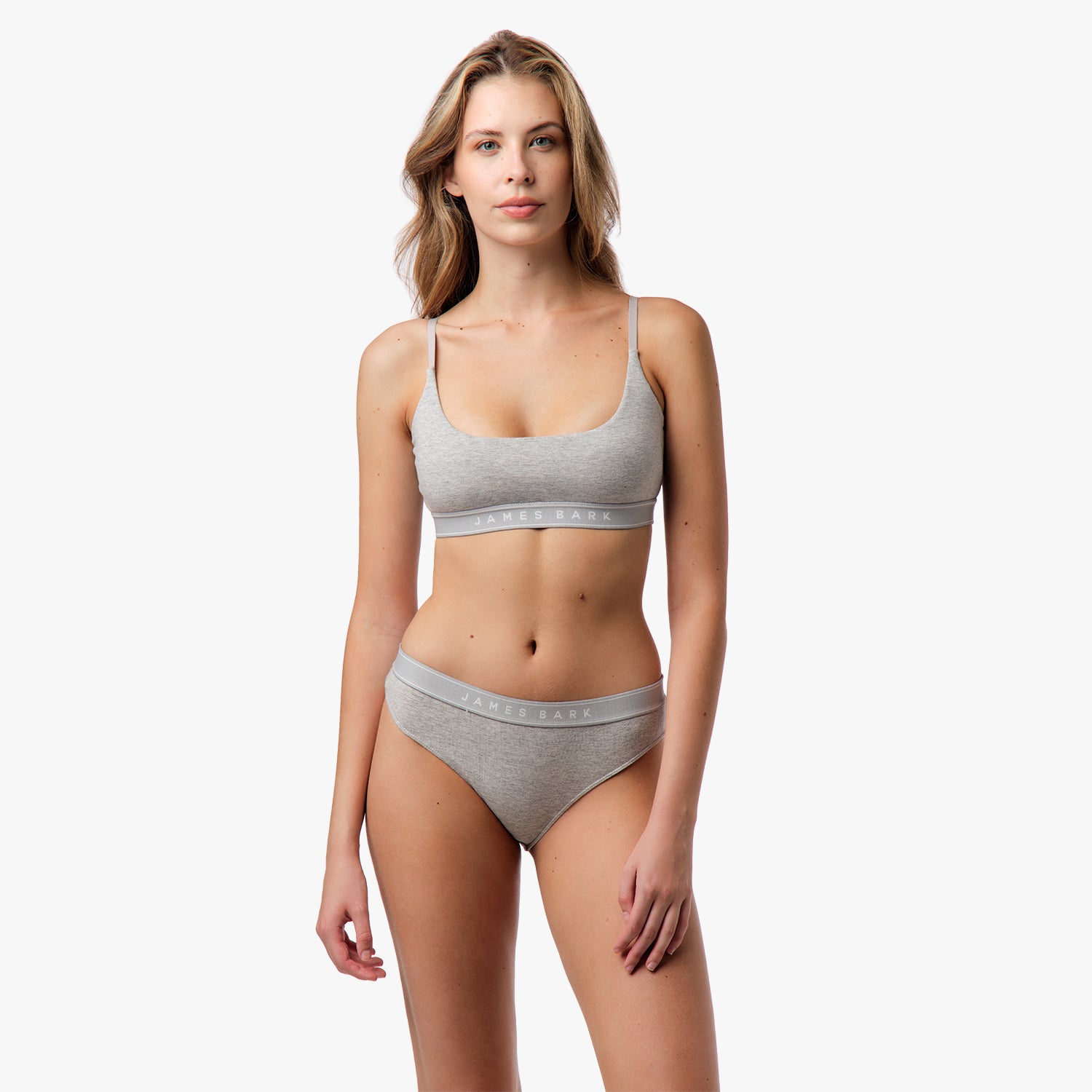 Front view of a woman wearing the matching gray bralette and underwear set.