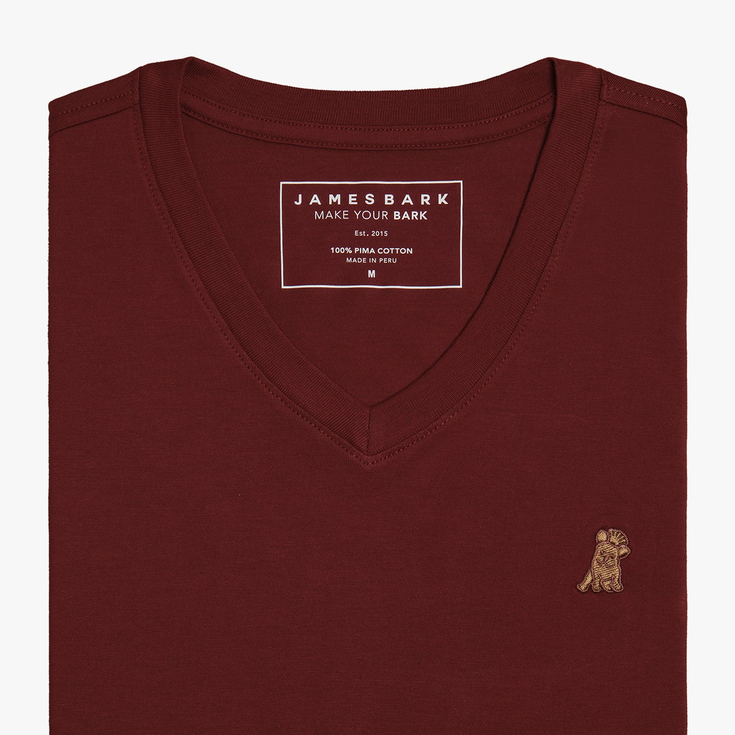 Close-up view of the burgundy V-neck t-shirt laid flat, highlighting the collar and small embroidered logo.