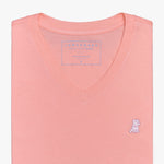 Close-up view of the coral V-neck t-shirt laid flat, highlighting the collar and small embroidered logo.