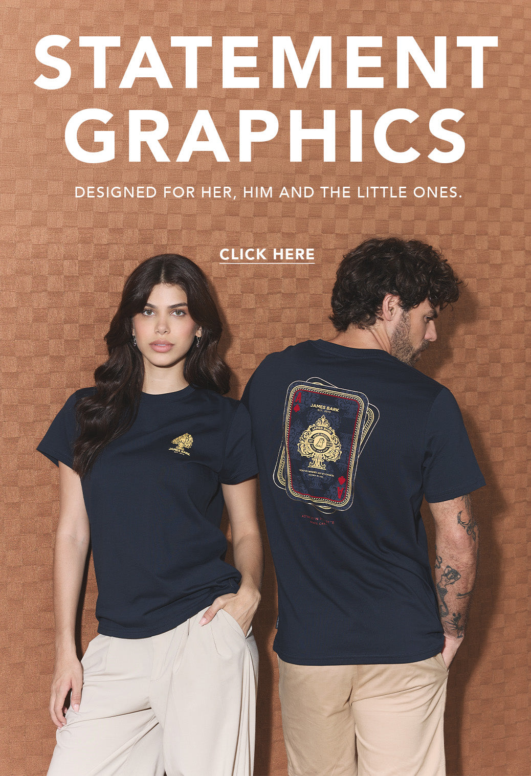 A promotional graphic for Statement Graphics featuring a man and a woman modeling navy blue T-shirts against a textured brown background. The woman wears a t-shirt with a small gold graphic on the chest, while the man wears a back view of the same t-shirt showing a large graphic print.