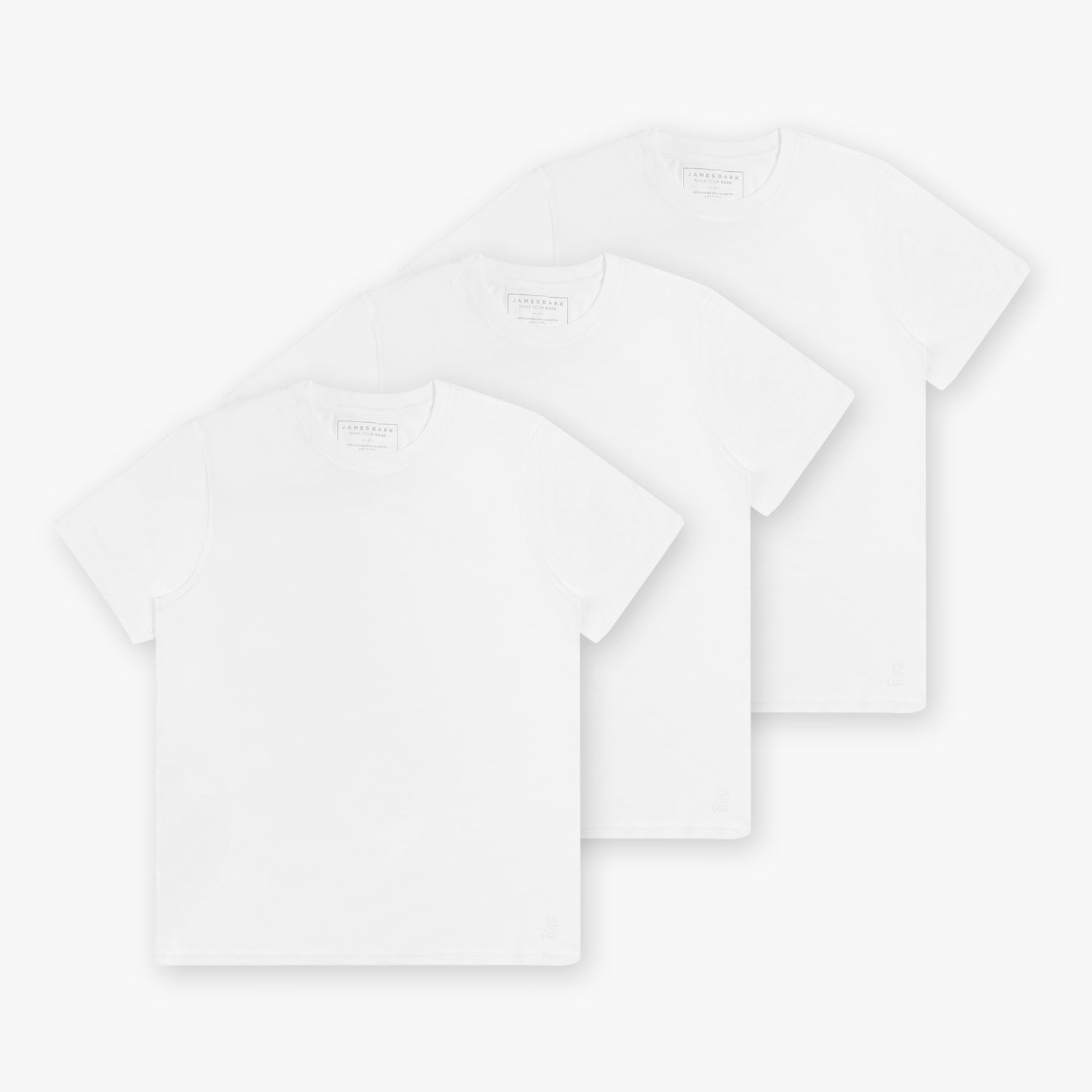 Three white t-shirts neatly arranged in a stack, showcasing the clean and minimalist design of the t-shirts with a subtle logo detail.