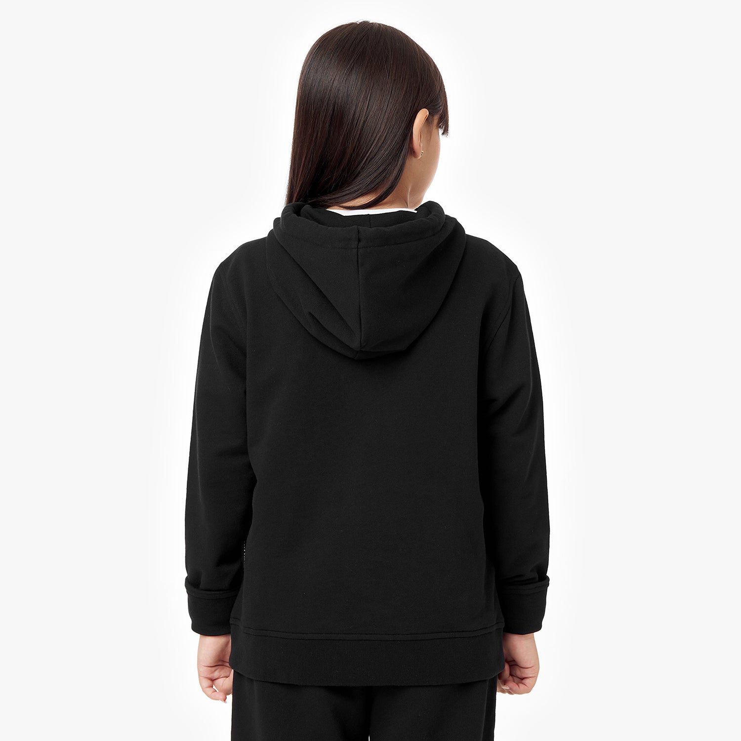 Back view of a child wearing the black hoodie, showcasing the hood and minimalist design.