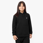 Front view of a child wearing a black hoodie with a small embroidered dog logo on the chest, paired with matching jogger pants and standing confidently.