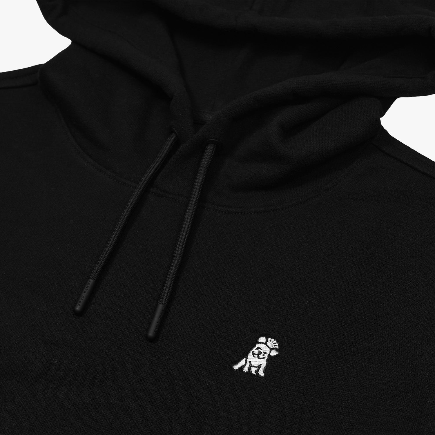 Close-up of the hood and embroidered dog logo on the black hoodie, emphasizing the fine details and fabric texture.