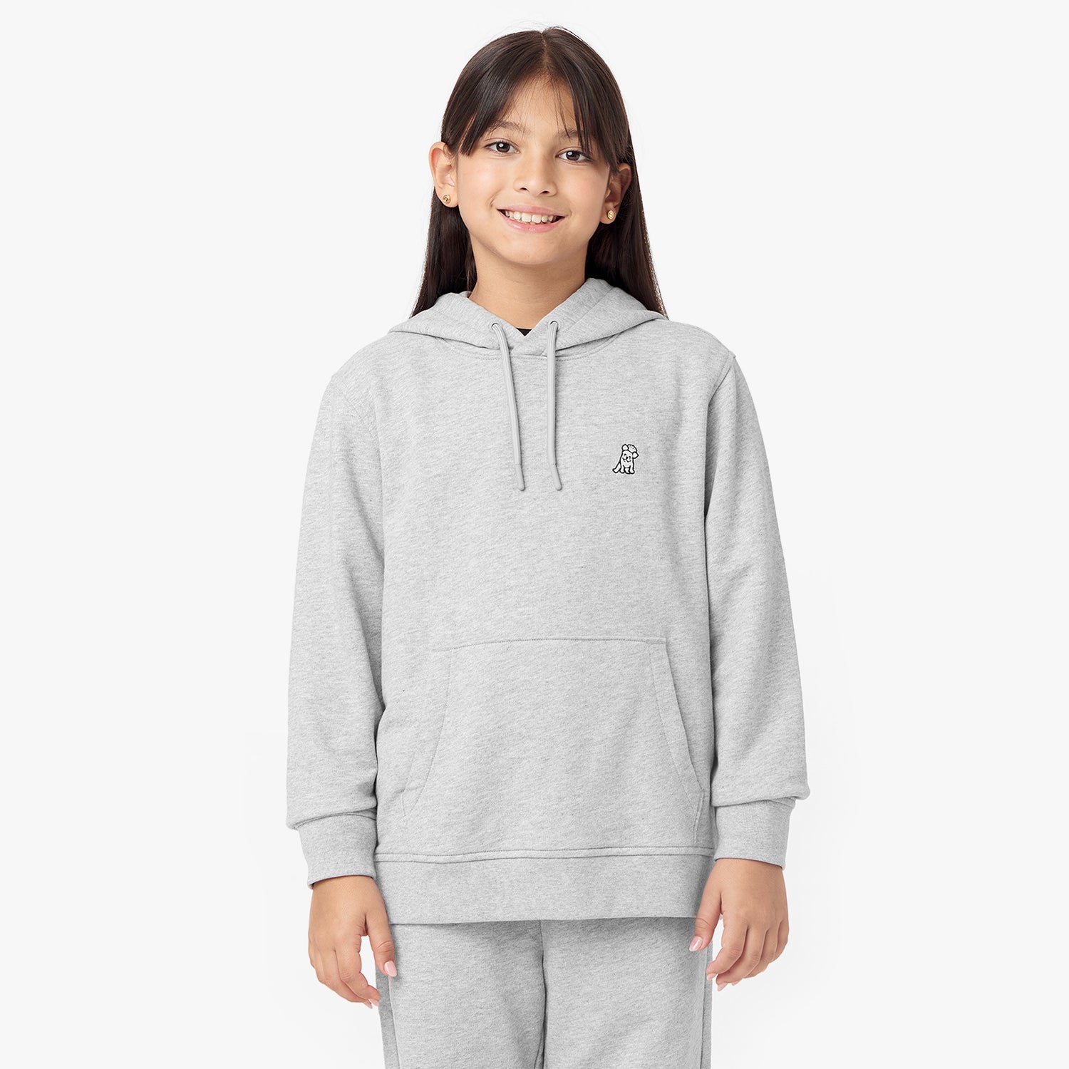 Front view of a child wearing the gray hoodie, smiling confidently, paired with matching jogger pants